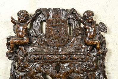 A Flemish reticulated oak panel with a carpenters' guild coat of arms, late 16th C.