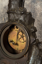 A French patinated and gilt bronze 'ruin' clock with matching candlestick, 19th C.