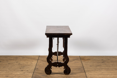 A Spanish walnut table with wrought iron connection, 19th C.