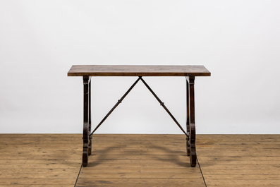 A Spanish walnut table with wrought iron connection, 19th C.