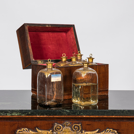 An English mahogany liqueur cellar with six partly gilt carafes, 19th C.