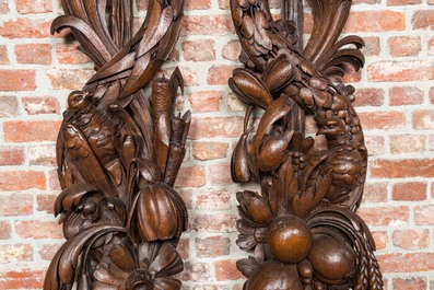 A pair of large carved oak reliefs with birds among fruit and flower scraps, 18th C.