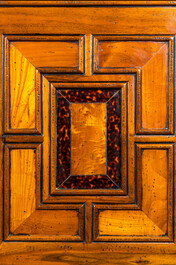 A cabinet on foot in various woods inlaid with faux tortoiseshell, 20th C.