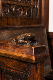 A large Gothic Revival oak hooded throne chair with dragons and frogs, 19th C.