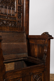 A large Gothic Revival oak hooded throne chair with dragons and frogs, 19th C.