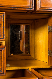 A cabinet on foot in various woods inlaid with faux tortoiseshell, 20th C.