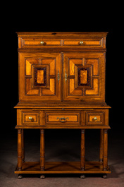 A cabinet on foot in various woods inlaid with faux tortoiseshell, 20th C.