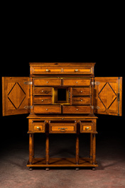 A cabinet on foot in various woods inlaid with faux tortoiseshell, 20th C.