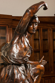 A large walnut figure of an angel, Flanders, 17th C., on a later stand