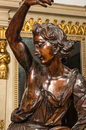 A large walnut figure of an angel, Flanders, 17th C., on a later stand