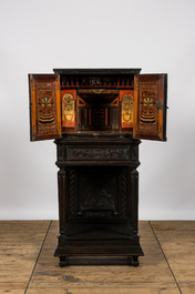 A neoclassical ebonised wooden cabinet on foot with an interior with parquetry and polychrome design, 18th C. and later