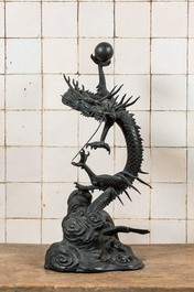 A large Japanese bronze okimono with a dragon holding the pearl of wisdom, Meiji, 19th C.