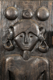 A decorative wooden African-inspired single-door cupboard, 20th C.