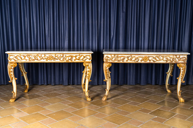 A pair of Italian patinated and gilt wooden wall consoles with marble top, 18th C.