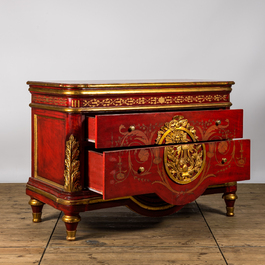 A red lacquered and gilt chest of drawers, 20th C.