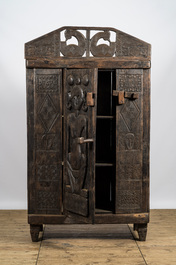 A decorative wooden African-inspired single-door cupboard, 20th C.