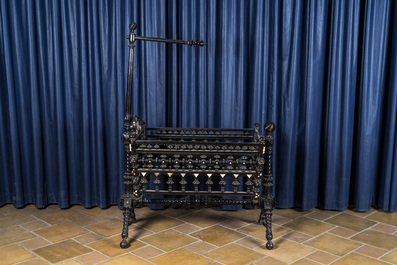 An attractive ebony-inlaid ebonised wooden cradle, 19th C.