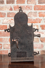 A large wrought iron lock with key, 17/18th C.
