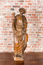 A wooden sculpture of a saint, 17th C.