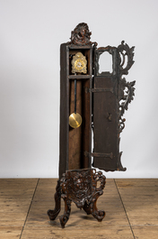 A richly carved walnut tripod clock, 19th C.