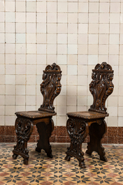 A pair of Italian wooden 'sgabello' chairs with a mascaron, 19th C.