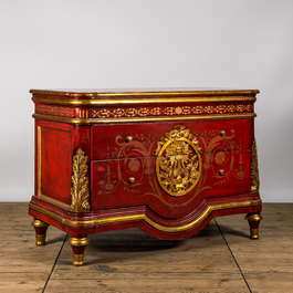 A red lacquered and gilt chest of drawers, 20th C.