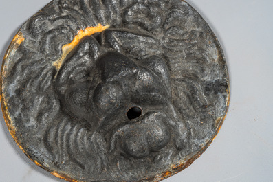 Four cast iron medallions with a lion's head, 19th C.