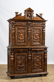 A richly carved baroque-style oak and walnut four-door cabinet, 19th C.