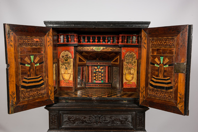 A neoclassical ebonised wooden cabinet on foot with an interior with parquetry and polychrome design, 18th C. and later