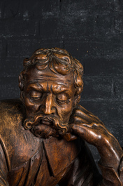 A large walnut sculpture of a resting man, 18/19th C.