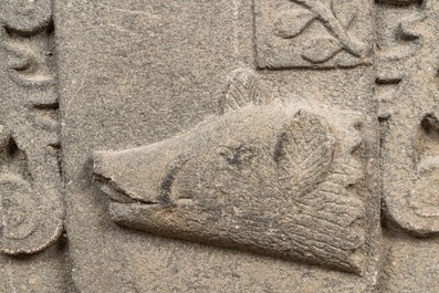 A carved stone relief with a coat of arms with the head of a wild boar, 19th C.