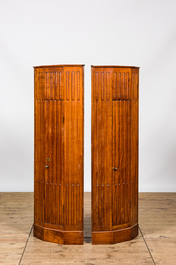 A pair of fluted wooden corner cabinets, 19/20th C.