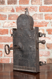 A large wrought iron lock with key, 17/18th C.