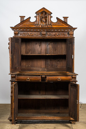 A richly carved baroque-style oak and walnut four-door cabinet, 19th C.