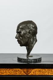 A patinated bronze head of a man on marble stand, illegibly signed and dated (19)29