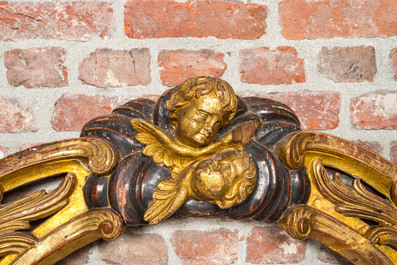 A gilt and polychrome wooden arch with archangels and putti, 18th C.