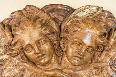 A wooden relief depicting two angels with traces of polychrome and gilt, 18th C.