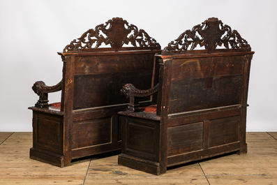 A pair of richly carved wooden hall benches, 19th C.