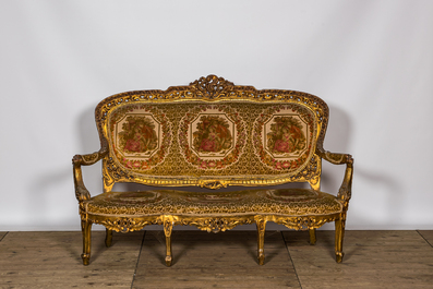 A Louis XV-style gilt wooden salon set comprising a three-seater sofa and two armchairs, 20th C.