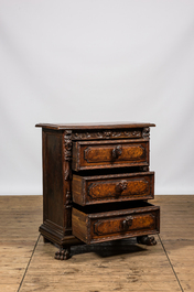 An Italian richly decorated walnut and burl wood chest of drawers with mascarons, 19th C.
