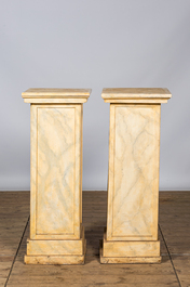 A pair of wooden 'faux marbre' pedestals, 20th C.