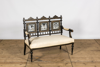 An English ebonised wooden sofa with mother-of-pearl inlaid and three Minton Waverley plaques by John Moyr Smith (1839-1912), 19th C.