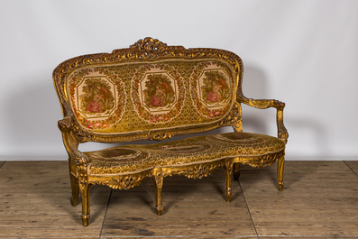 A Louis XV-style gilt wooden salon set comprising a three-seater sofa and two armchairs, 20th C.