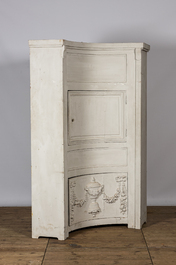 A neoclassical whitewashed corner cabinet, 19th C.