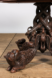 An Anglo-Indian colonial table on a well-carved stand with lions and peacocks, 19th C.