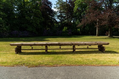 An impressive long wooden table with recesses from the dining room of an orphanage or monastery, 19th C.