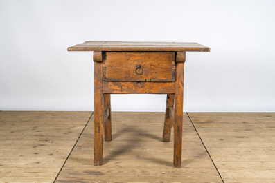 A rustic rural wooden table with drawer, 19th C.