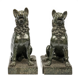 A pair of green porphyry sculptures of seated dogs, 1st half 20th C.