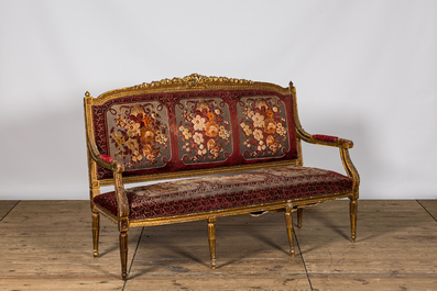 A neoclassical gilt wooden salon set comprising a sofa and four armchairs, 20th C.