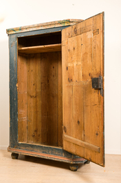 A German painted wooden one-door cupboard, 19th C.
